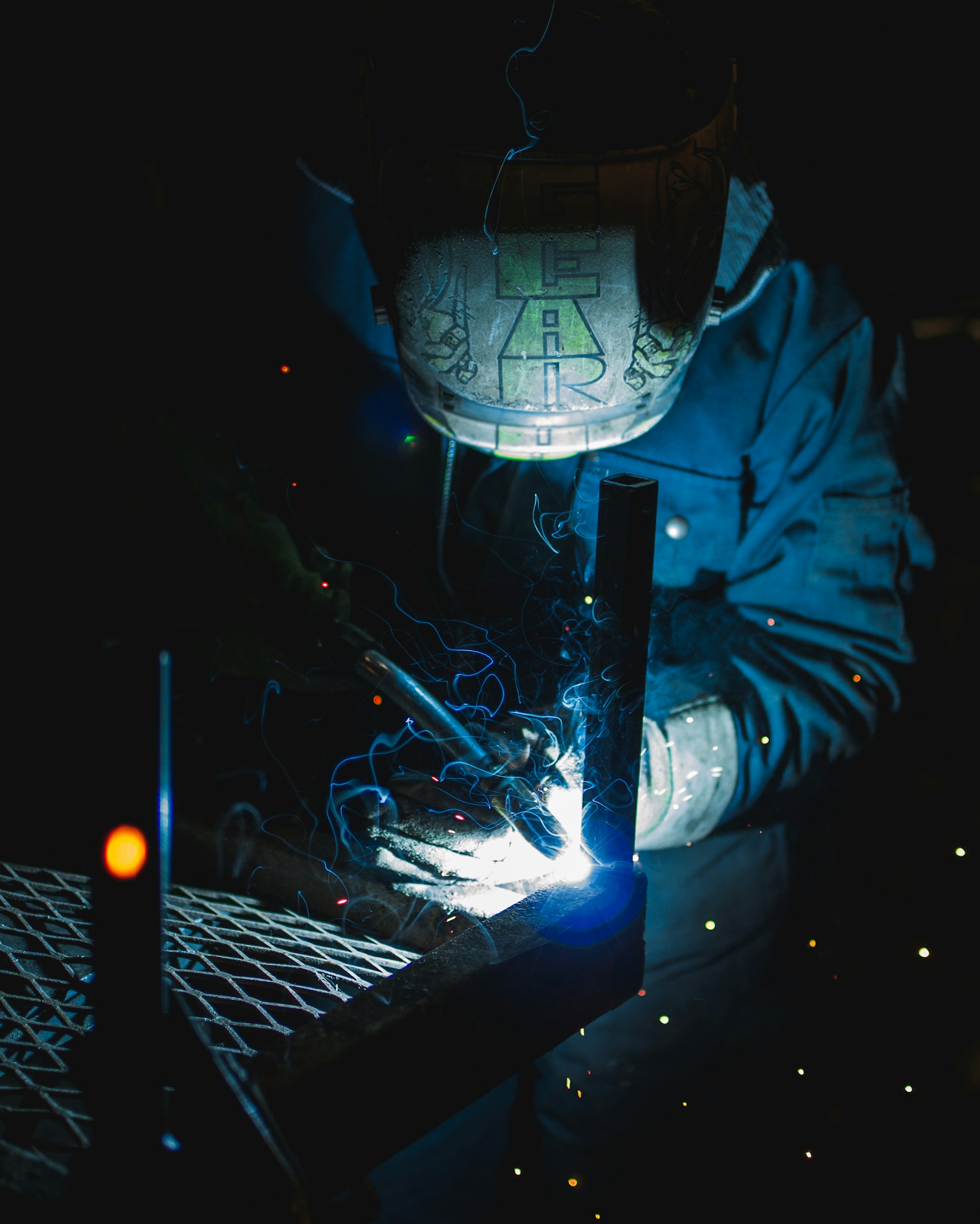 A man is welding in a protective helmet.